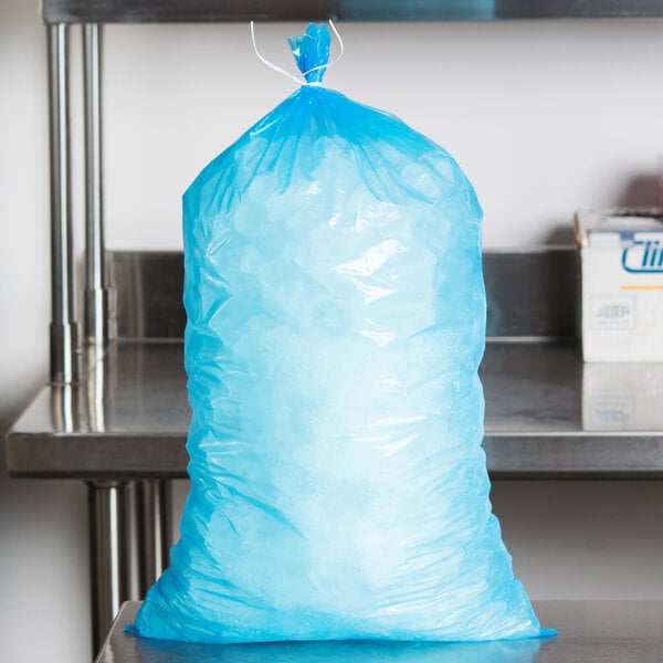 A blue plastic bag with ice on a counter.