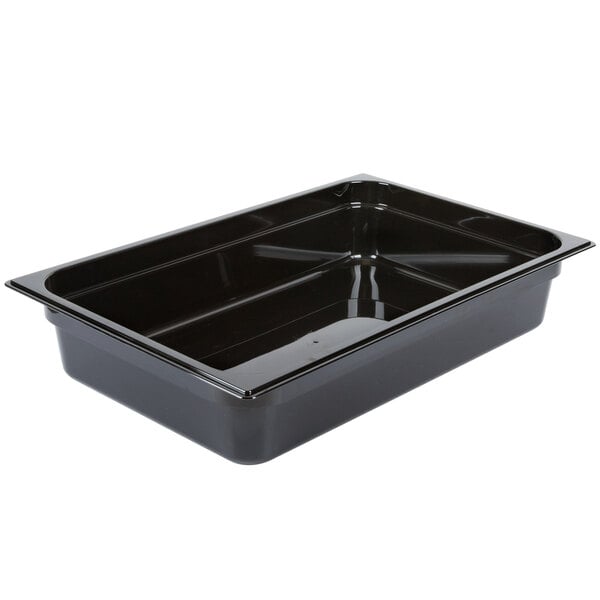 A Carlisle black plastic food pan on a counter.