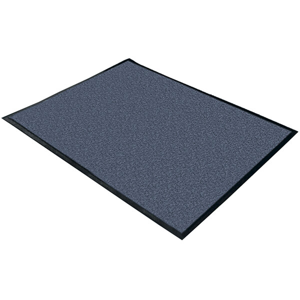 A close-up of a blue rubber-backed carpet with black trim.