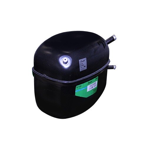 A black round compressor with a green label and barcode.