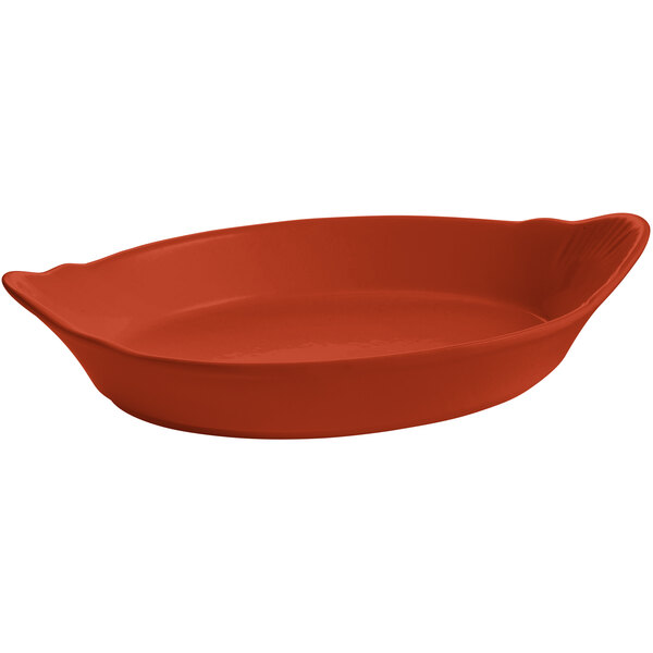 A red oval shaped Tablecraft copper au gratin dish with a handle.