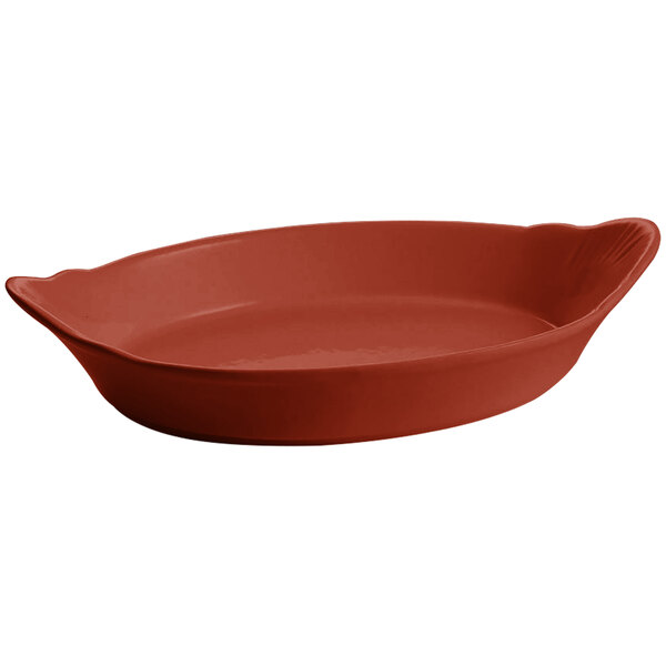 A red oval shaped Tablecraft copper au gratin dish.