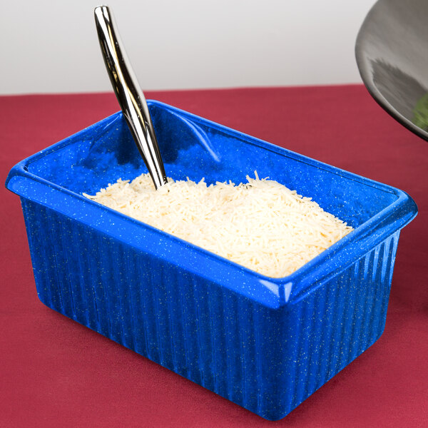 A Tablecraft blue rectangular server with white rice and a spoon.