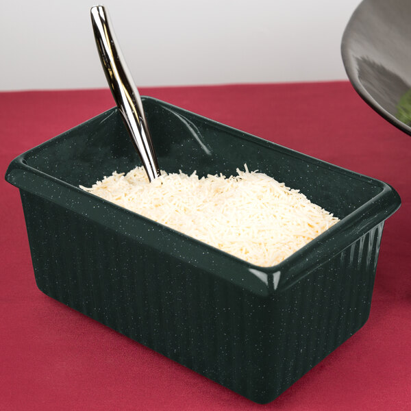 A Tablecraft hunter green rectangle server with white speckle holding rice with a spoon.