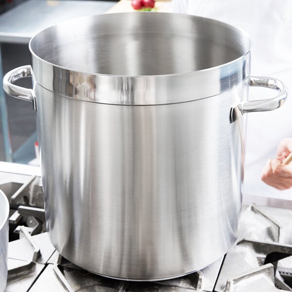 A large Vollrath stainless steel stock pot on a stove.
