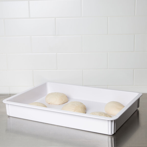 An American Metalcraft white ABS plastic dough box on a white surface filled with white dough.