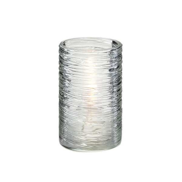 A Sterno clear glass twister candle holder with a lit candle inside.