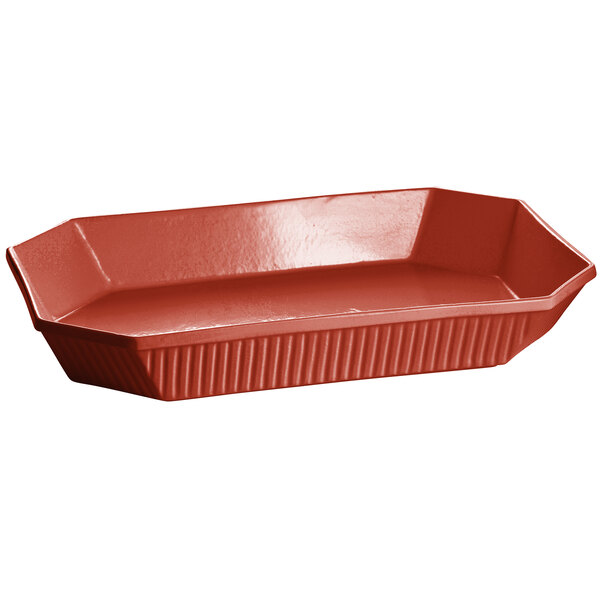 A copper octagon casserole dish with a curved edge.