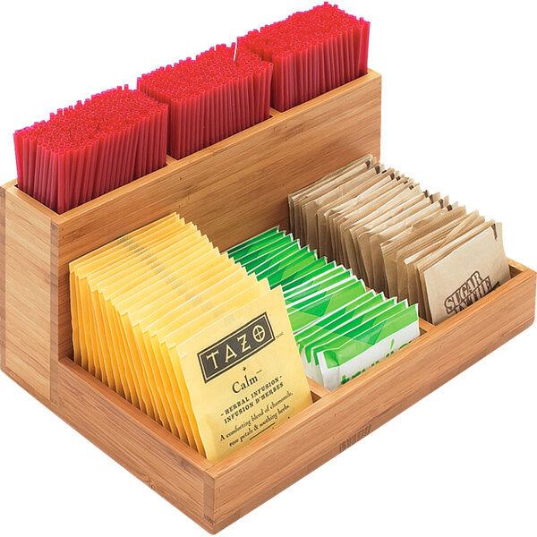 A wooden Cal-Mil organizer with different types of tea bags inside.