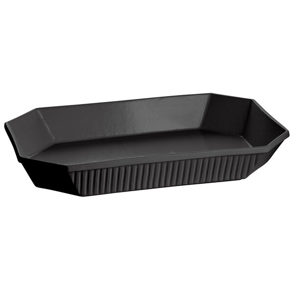 A black octagon cast aluminum casserole dish with a lid and handles.