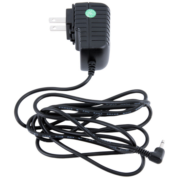 An Edlund black AC adapter with a green sticker on the cord.