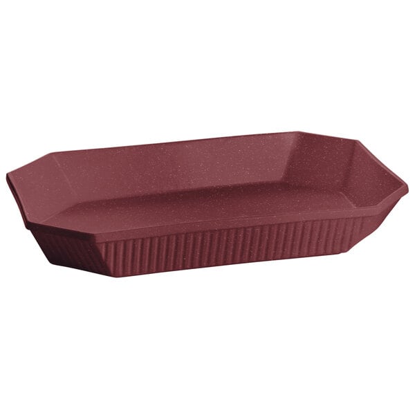 A maroon octagon casserole dish with a lid on a red tray.
