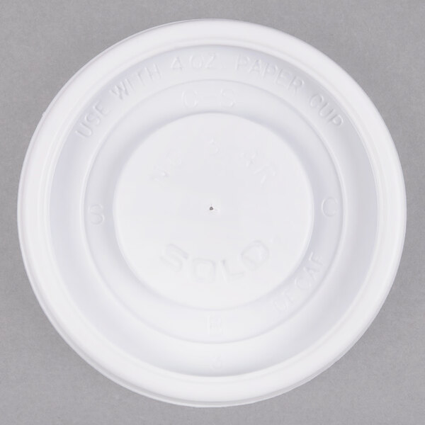 A Solo white plastic lid with a hole for a straw on top of a white paper cup.