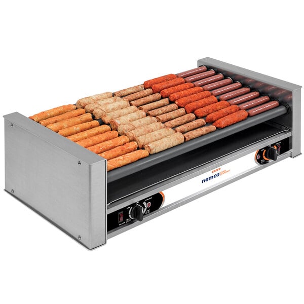 A Nemco Wide Slanted hot dog grill with hot dogs on it.