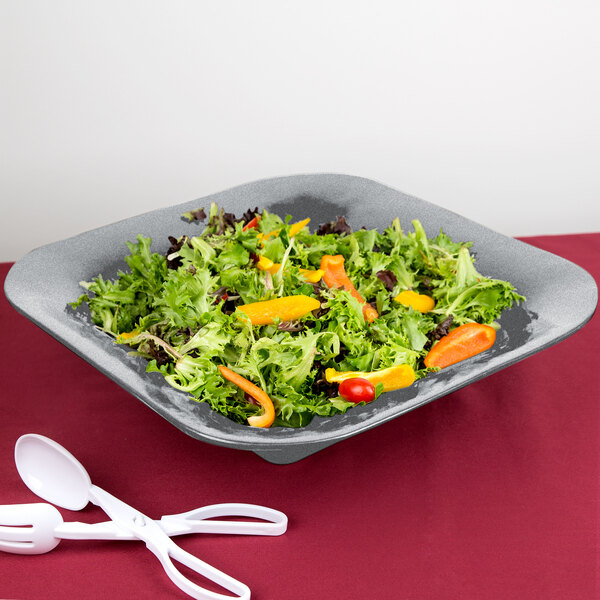 A Tablecraft granite square bowl filled with salad, carrots, and lettuce with forks and spoons.
