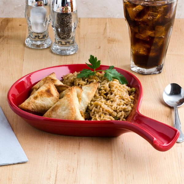 A Tuxton Cayenne fry pan server with rice and dumplings on a table.