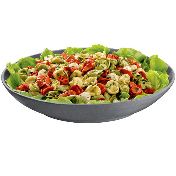 A Tablecraft granite pasta bowl filled with pasta, lettuce, and red and green tortellini.