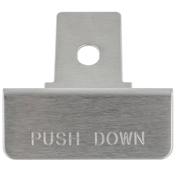 A close-up of a metal plate with the word "push" on it.