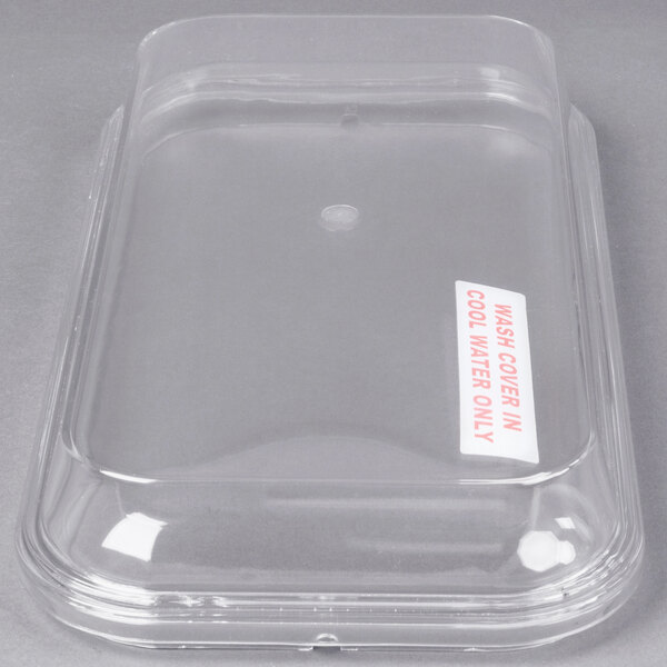 A clear plastic lid on a Grindmaster Cecilware refrigerated beverage dispenser bowl.