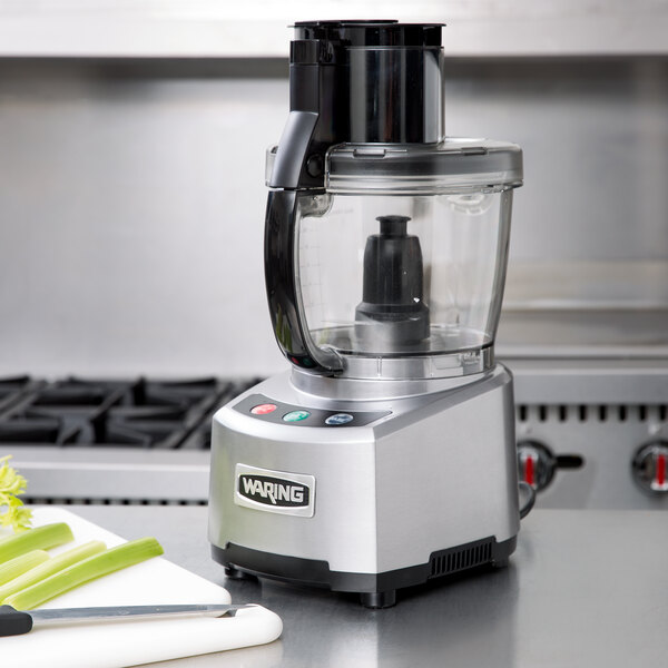 A Waring food processor on a counter in a professional kitchen.