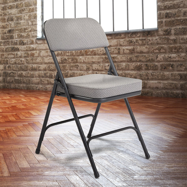 A National Public Seating black metal folding chair with a charcoal gray padded seat and back.