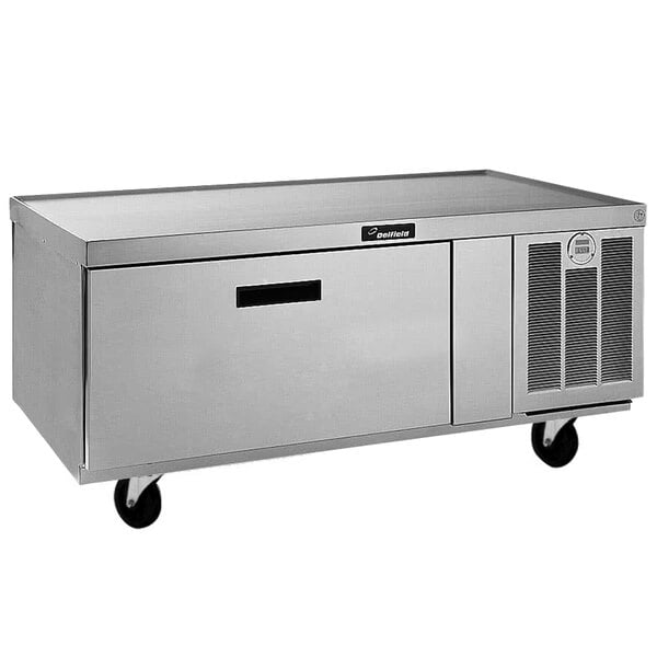 A Delfield stainless steel chef base with a drawer on wheels.