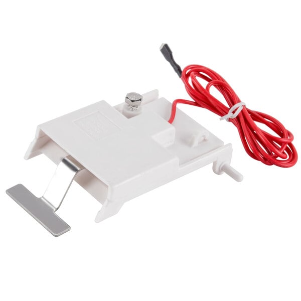A white electrical device with red wires.