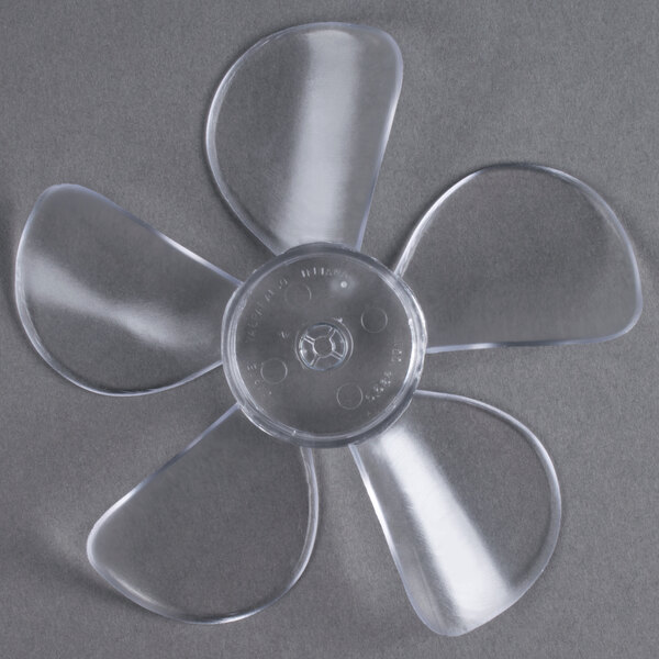 A close-up of a plastic fan blade with a flower-shaped design.