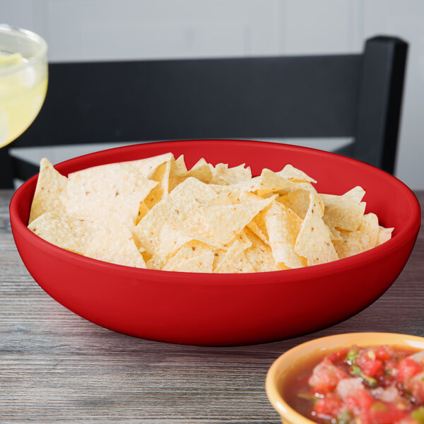 A red GET Sensation bowl filled with chips on a table.