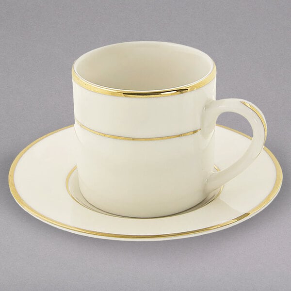 A 10 Strawberry Street white porcelain espresso cup and saucer with gold trim.