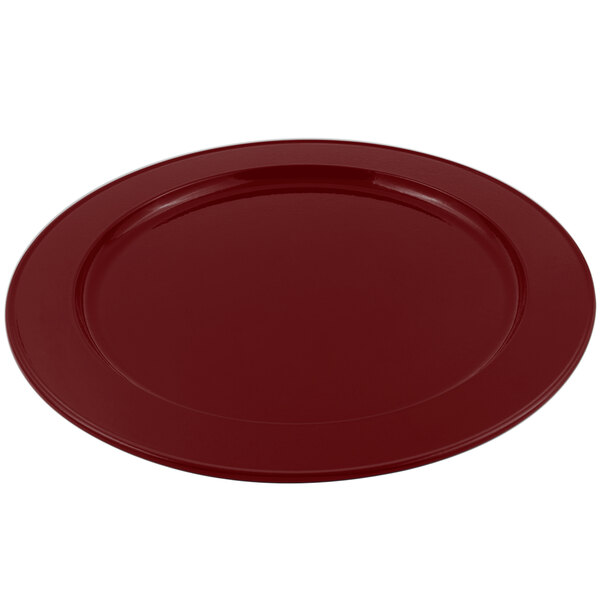 A Bon Chef Terra Cotta Sandstone finish cast aluminum platter on a table with a red plate.