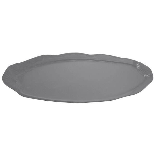 A gray cast aluminum shell and fish platter with a scalloped edge.