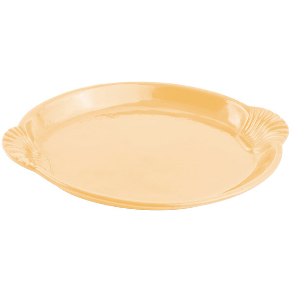 A Bon Chef ginger sandstone cast aluminum platter with a shell and fish design on the inside.