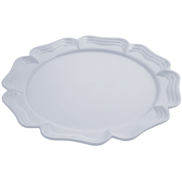 A pewter-glo round platter with a scalloped edge.