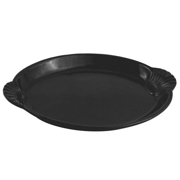 A black cast aluminum platter with a shell and fish design.