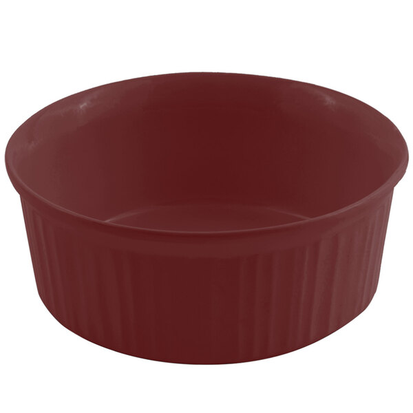 A red Bon Chef cast aluminum casserole dish with a lid on a white surface.