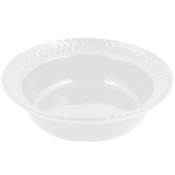 A white Bon Chef cast aluminum bowl with a decorative trellis design on the rim.