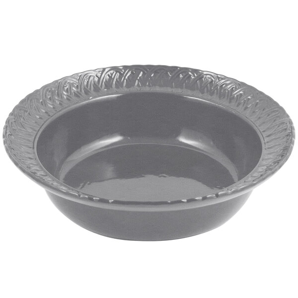 A gray Bon Chef cast aluminum bowl with a decorative edge.