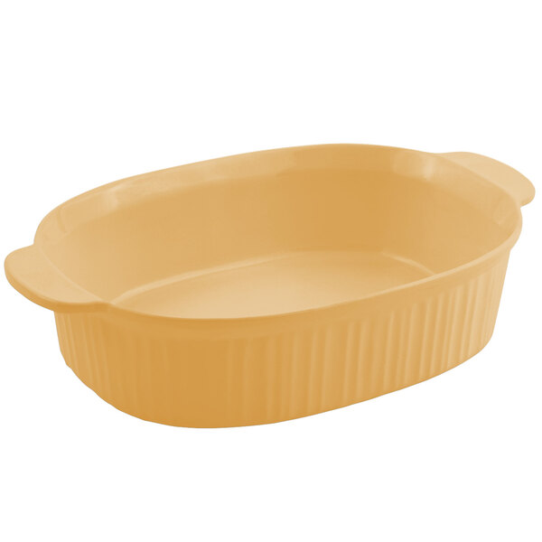 A Bon Chef ginger sandstone oval casserole dish with a lid.