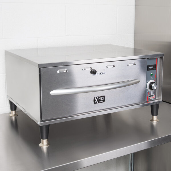 A stainless steel APW Wyott single drawer warmer on a counter.