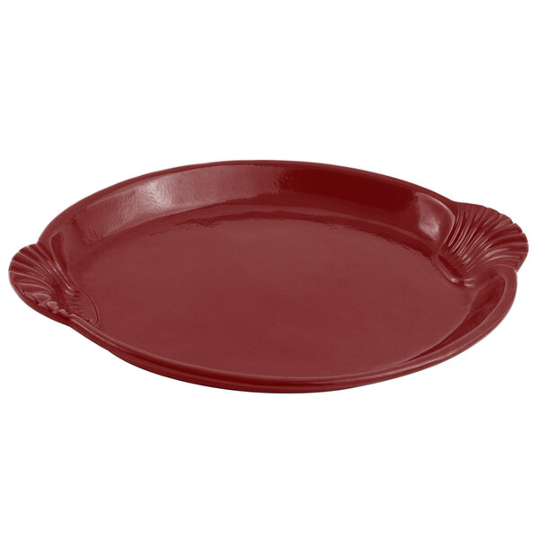 A red Bon Chef cast aluminum shell and fish platter with a scalloped edge.
