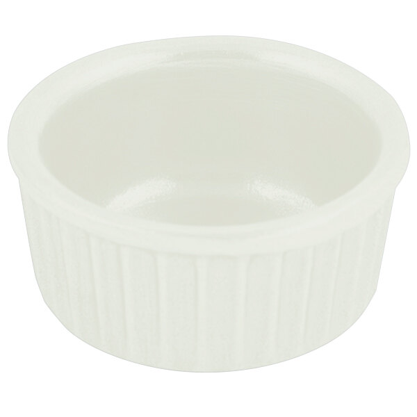 A Bon Chef ivory cast aluminum fluted ramekin with a ribbed edge and white interior.