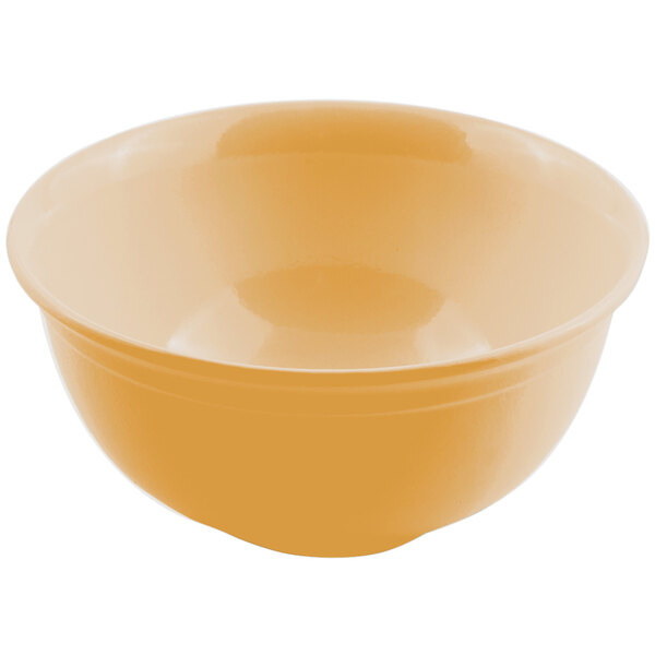 A close up of a Bon Chef ginger sandstone round bowl with a yellow surface and white border.