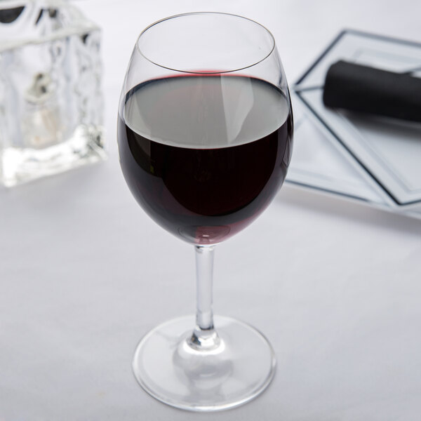 A Spiegelau Festival red wine glass full of red wine on a table.