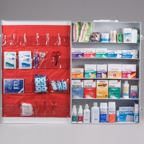 A white Medique first aid cabinet with many items inside.