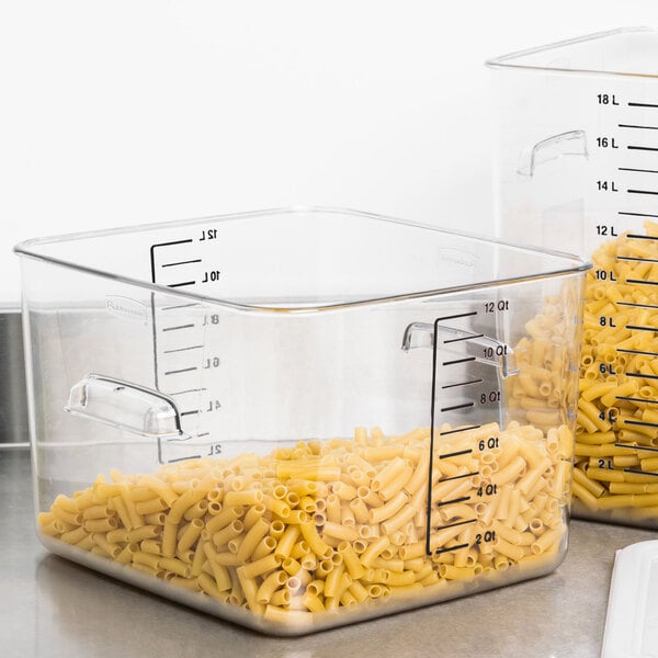 A Rubbermaid clear square plastic container filled with pasta on a counter.