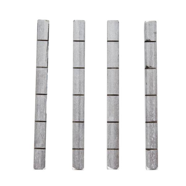 A group of gray rectangular metal rods with white rectangular objects.