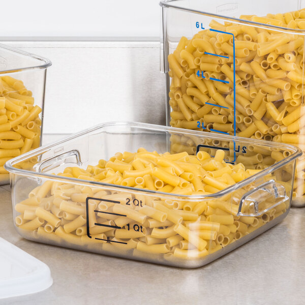 A Rubbermaid Clear Polycarbonate food storage container with pasta inside on a counter.