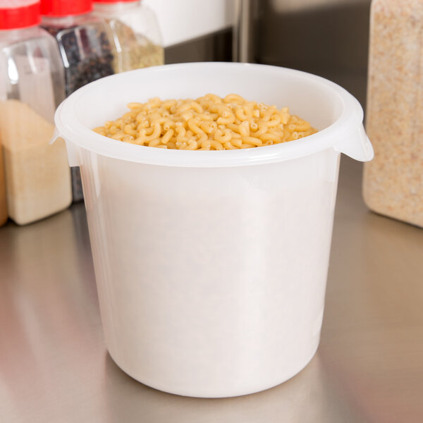 A Rubbermaid white round food storage container filled with rice on a counter.