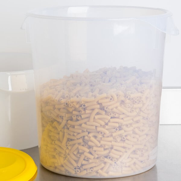 A translucent Rubbermaid round polypropylene container with pasta inside and a yellow lid.